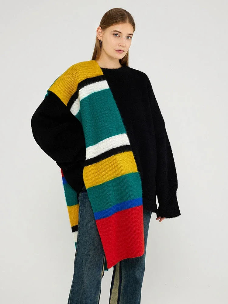 Woman wearing a black sweater and a multicolored striped knit scarf draped over her shoulder