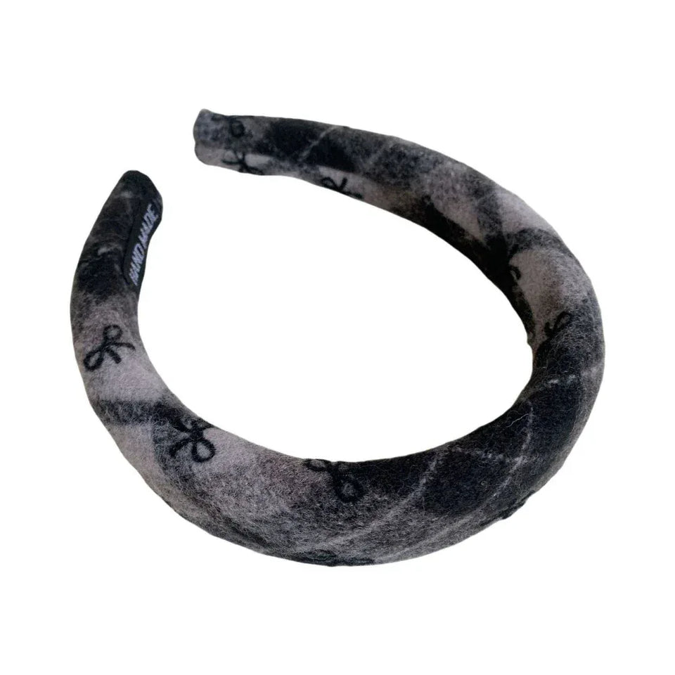 Padded headband with a black and gray plaid pattern and black bow accents. Main image