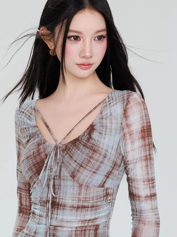 Detail of the sweetheart neckline and criss-cross straps on the plaid mesh dress.