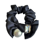 Black satin scrunchie with a metallic sphere and crystal embellishment