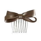 A single satin bow hair comb in a champagne color.