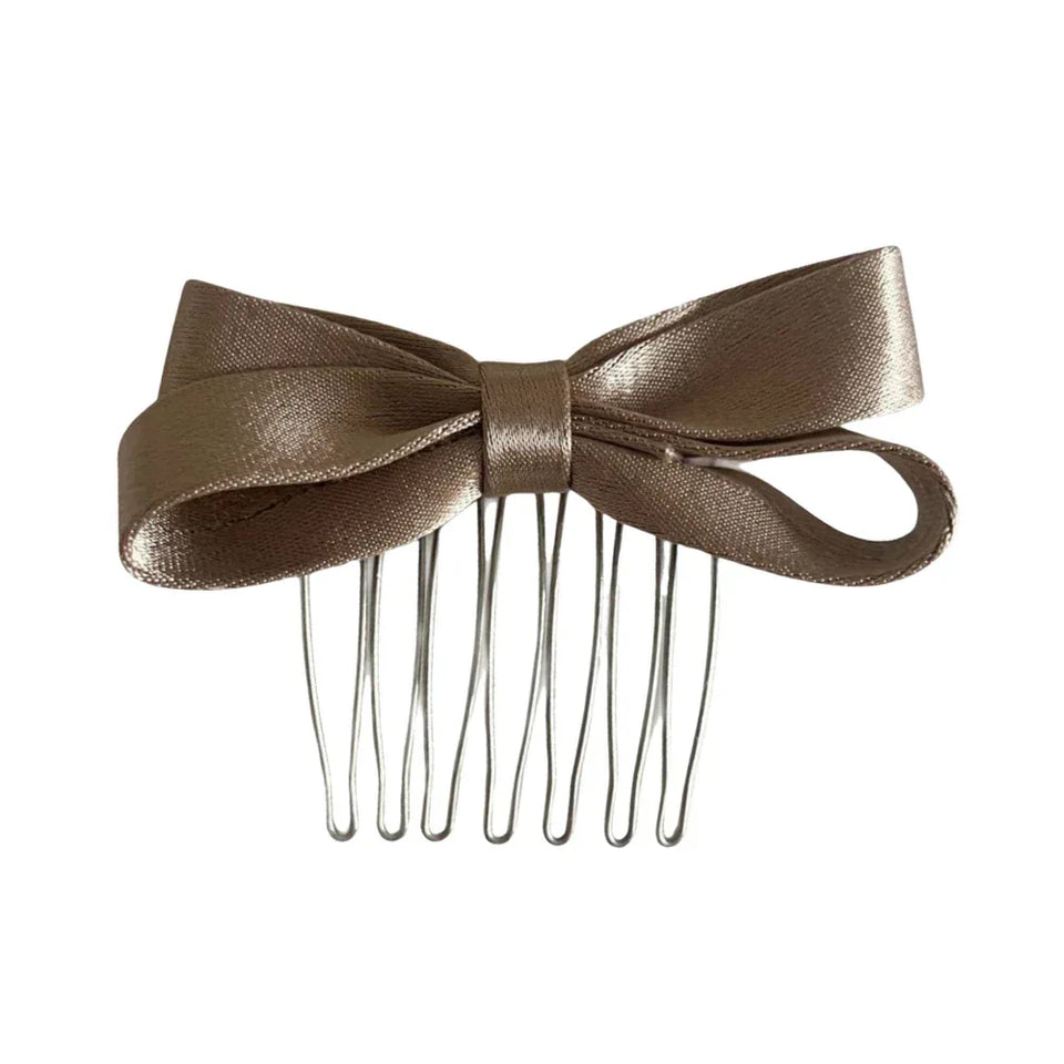 A single satin bow hair comb in a champagne color. Main image