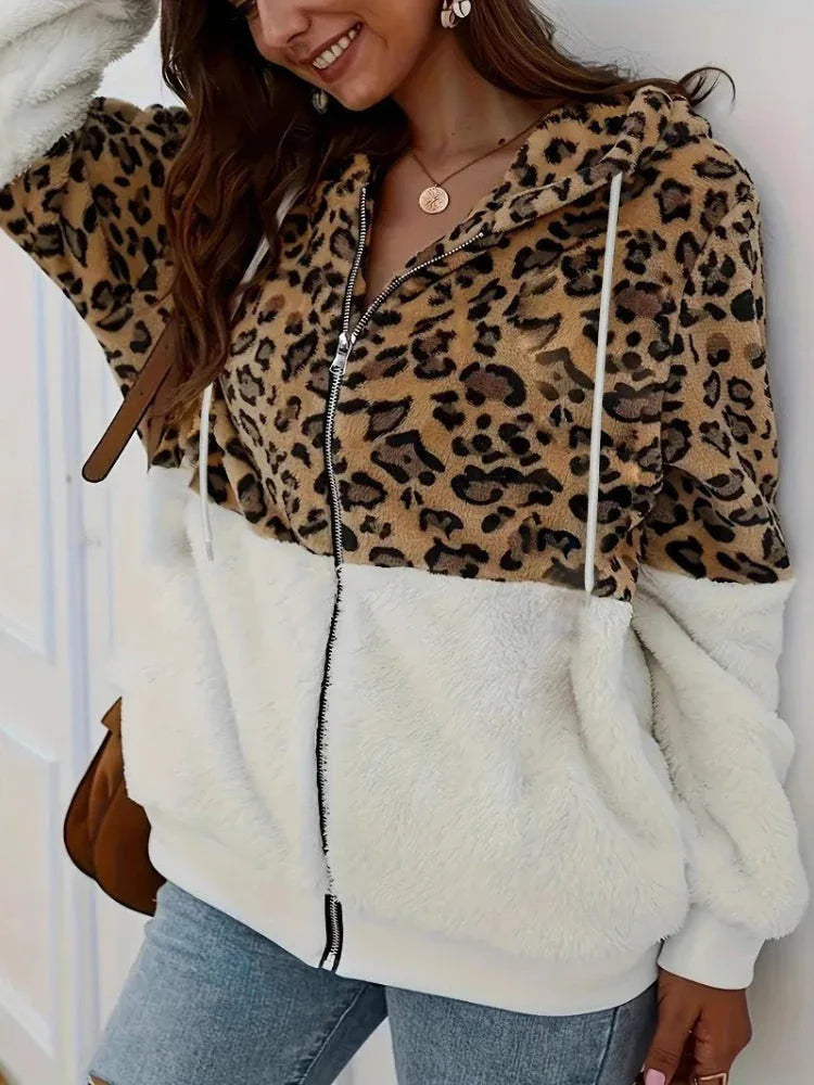 Woman wearing a leopard print and white sherpa hooded zip-up jacket. Main image