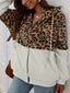 Woman wearing a leopard print and white sherpa hooded zip-up jacket.