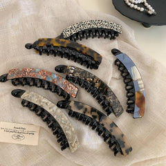 Variety of fashionable banana hair clips showcasing different artistic patterns