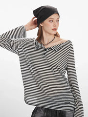 Model wearing a black and white striped off-the-shoulder long-sleeved shirt.