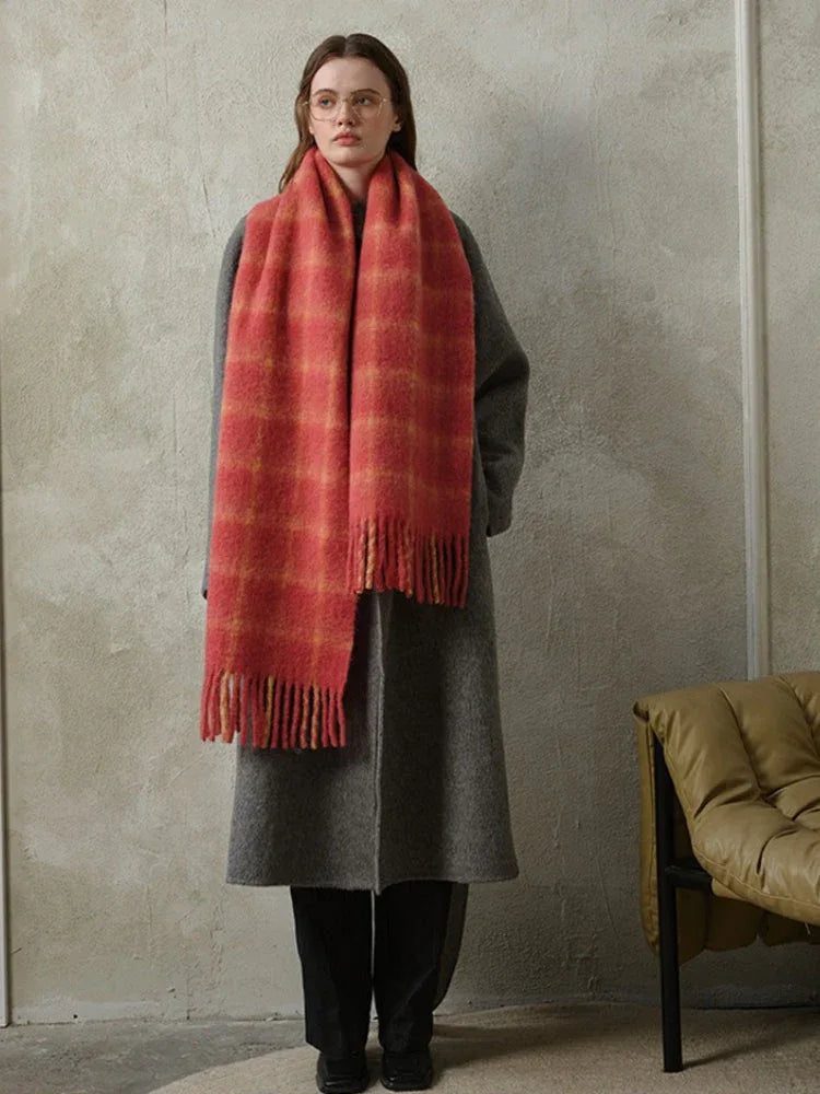 woman wearing a grey coat and a red plaid scarf