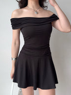 Front view of a black off-the-shoulder knit dress with ruched detailing.