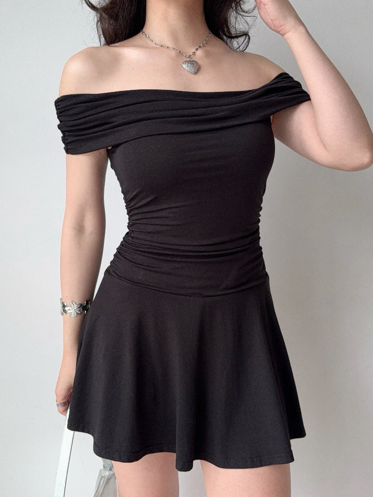 Front view of a black off-the-shoulder knit dress with ruched detailing.