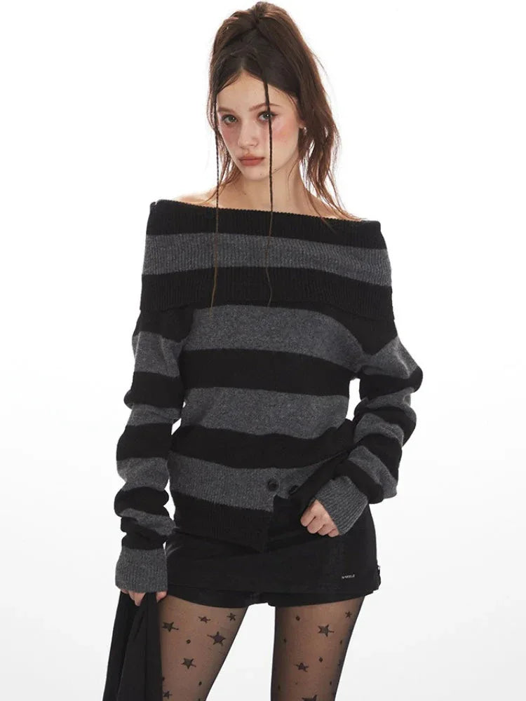 Model wearing a grey and black striped sweater styled off-the-shoulder, black shorts, black tights with stars, and black boots.
