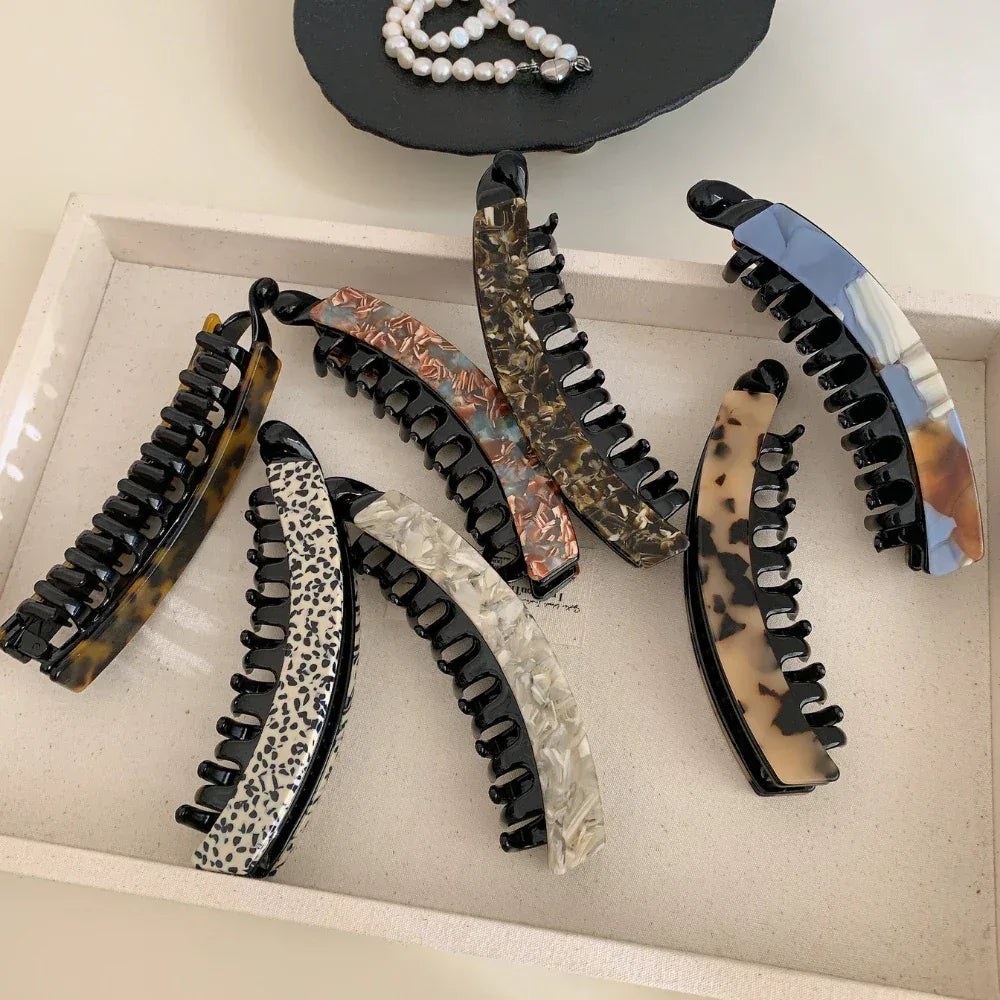 Group of elegant banana hair clips laid out on a tray