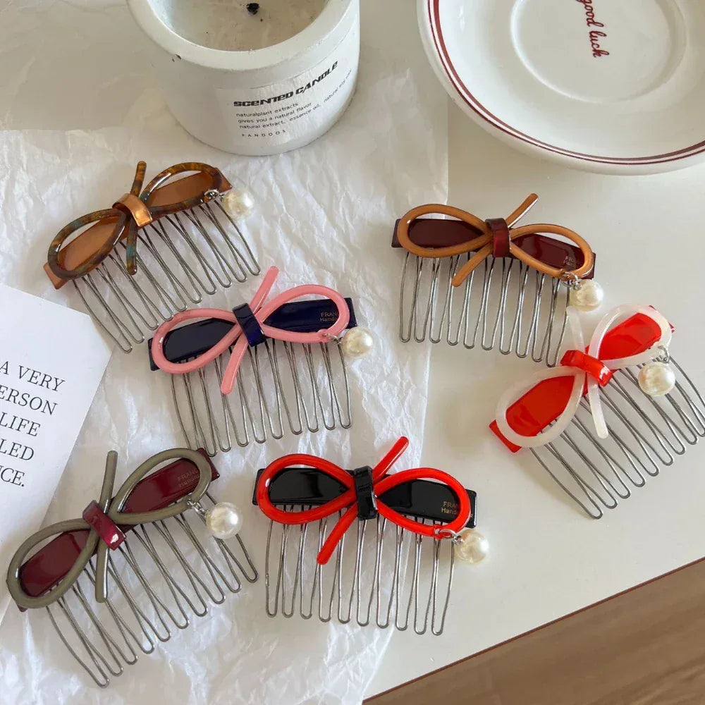 A collection of hair combs with bow and pearl accents in various colors.