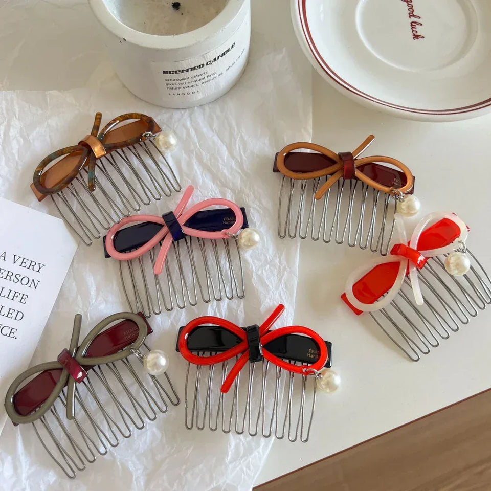 A collection of hair combs with bow and pearl accents in various colors. Secondary image