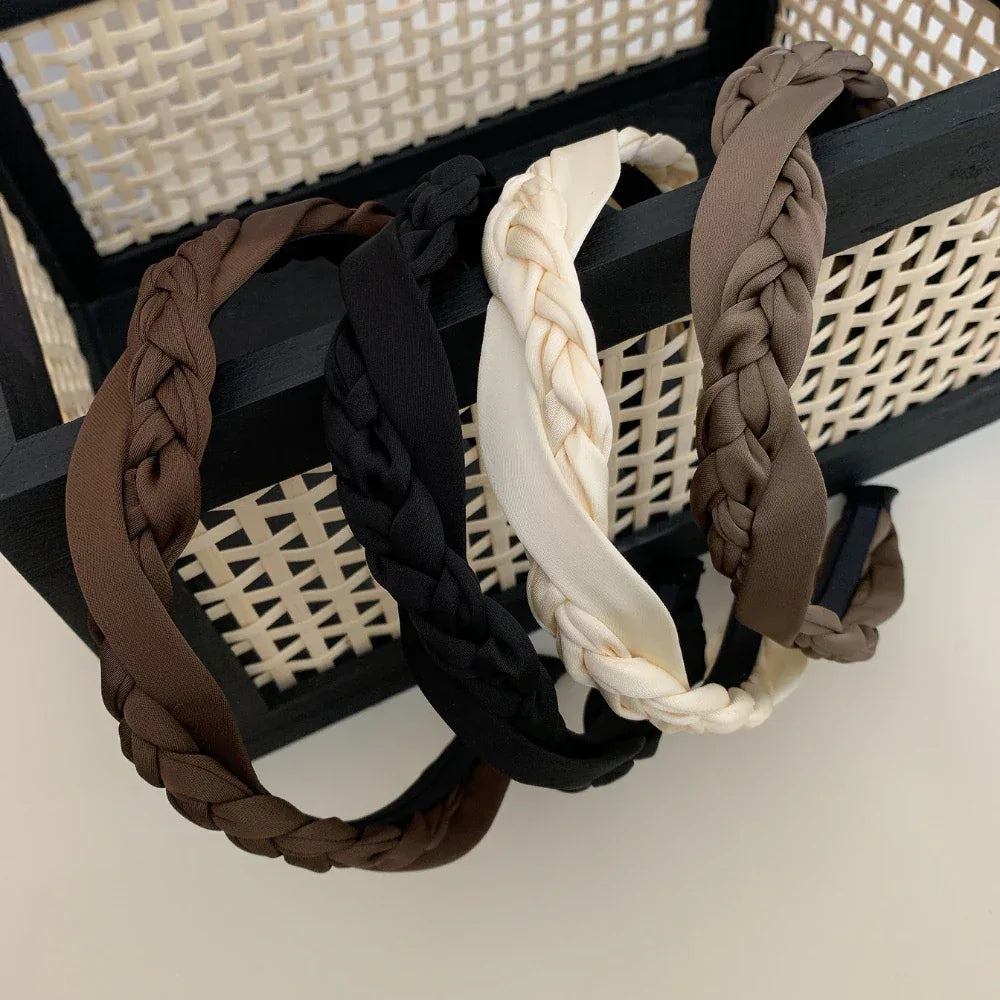 Group of braided headbands in black, cream, and brown shades