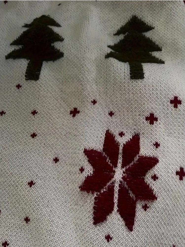 Close-up of the white knitted fabric with Christmas tree and snowflake print.