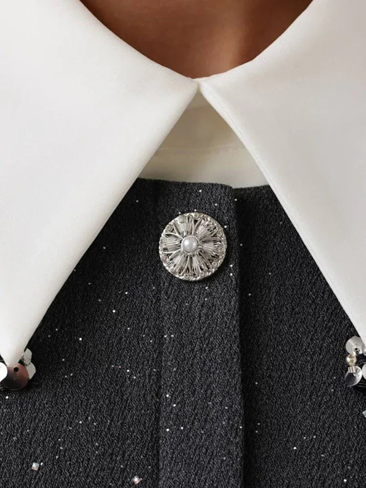 Detailed view of the button and collar embellishments on the grey tweed mini dress