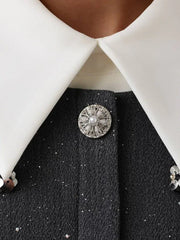 Detailed view of the button and collar embellishments on the grey tweed mini dress