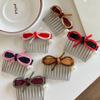 A group of decorative hair combs featuring bows and pearls in different shades.