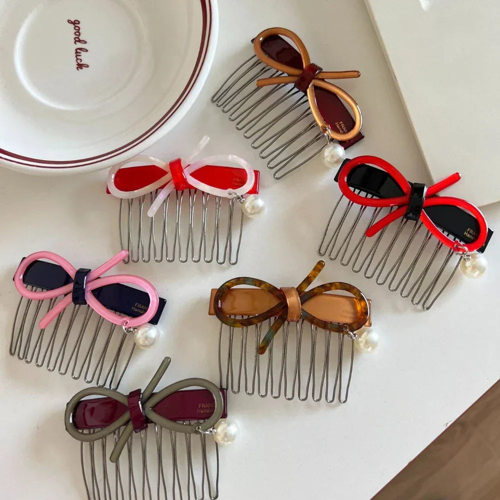 A group of decorative hair combs featuring bows and pearls in different shades.
