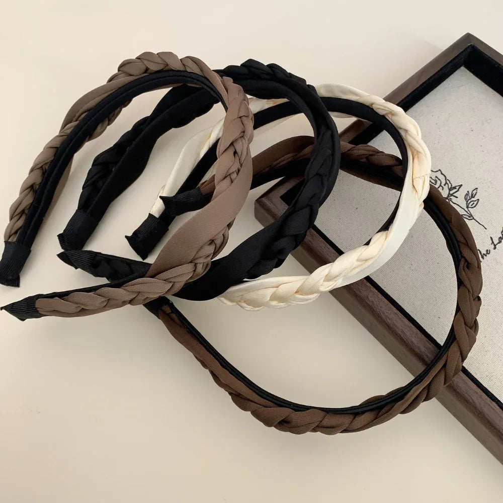 Collection of braided headbands in brown, black, and cream