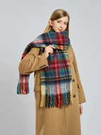 Woman posing with a plaid scarf wrapped around her neck