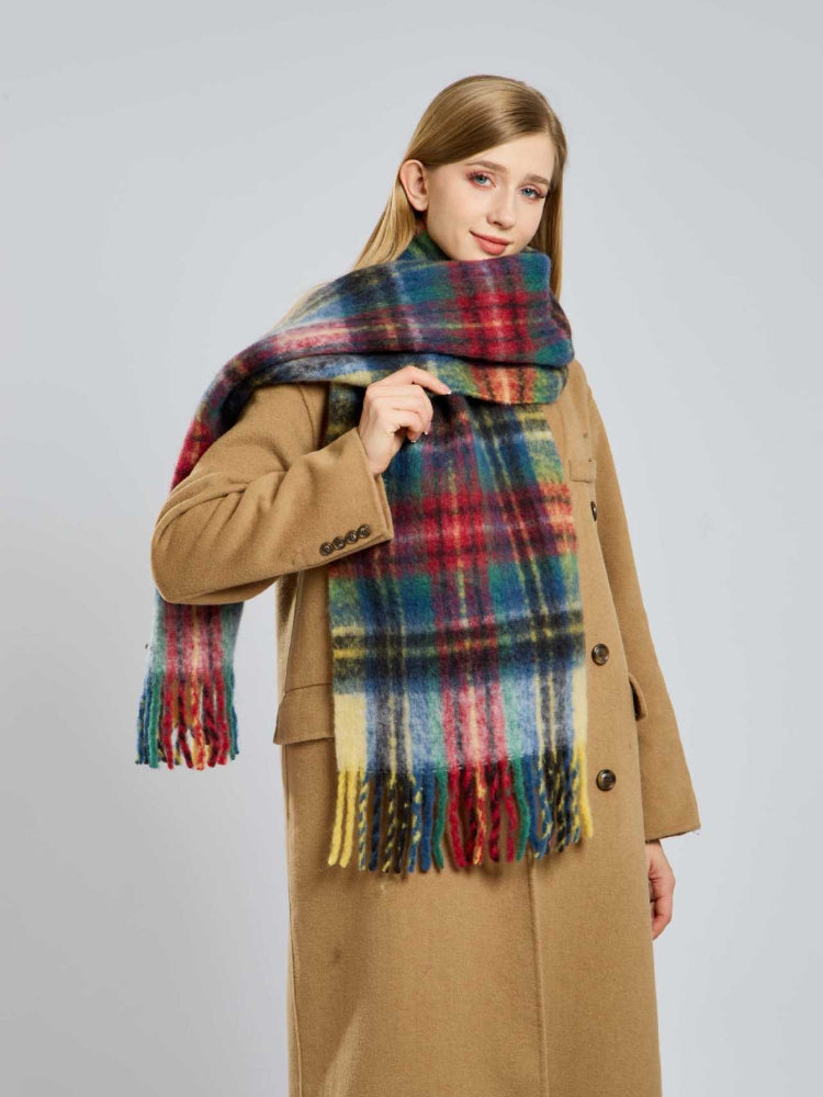 Woman posing with a plaid scarf wrapped around her neck