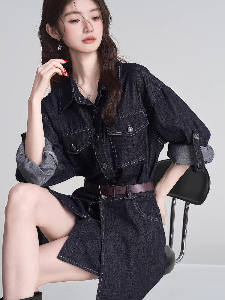 Woman wearing a dark wash denim shirt dress with a brown belt, sitting on a chair.