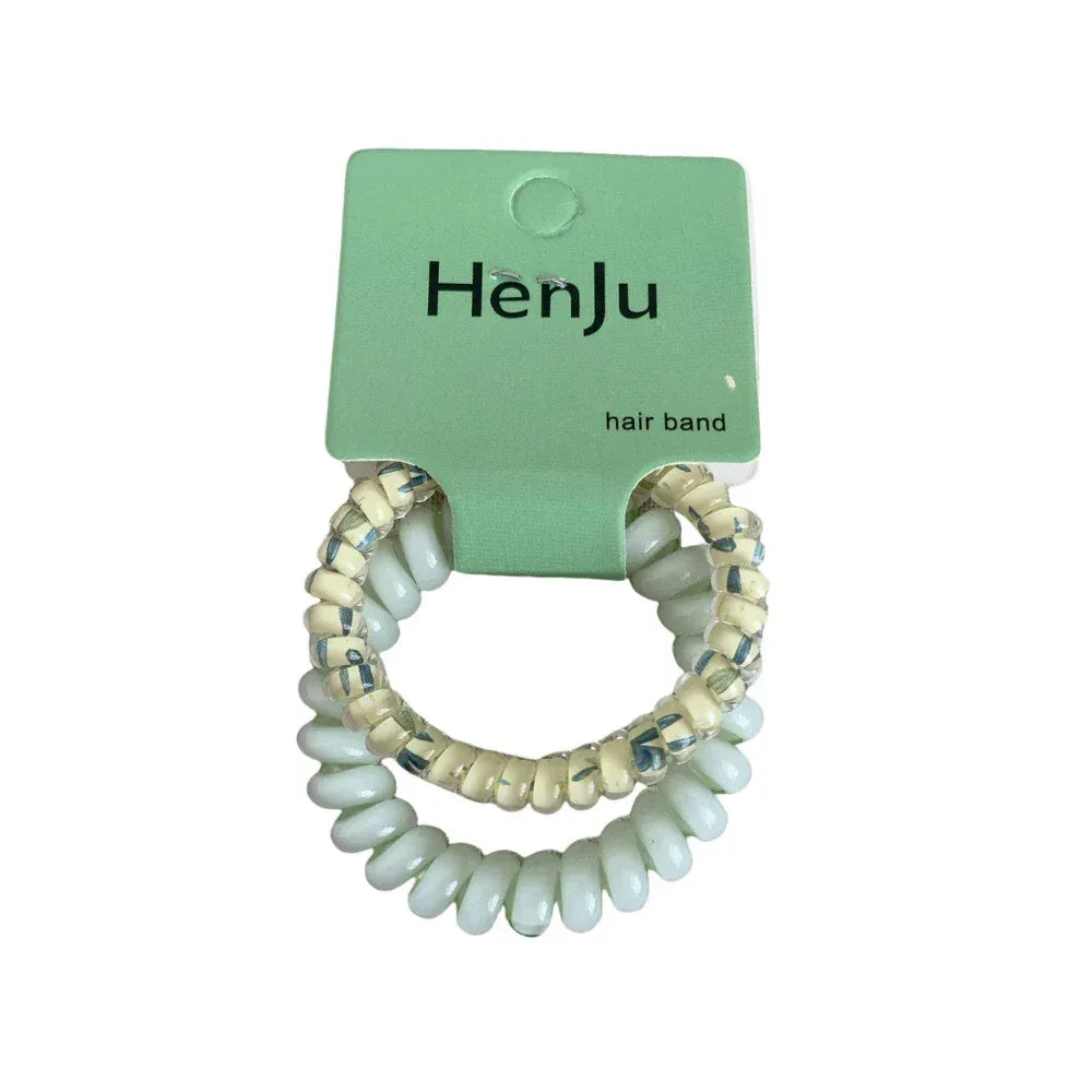 A pair of light blue spiral hair ties with beaded accents, packaged on a green card.