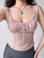 Close-up of a pink striped ribbed knit top with a sweetheart neckline and tie front.