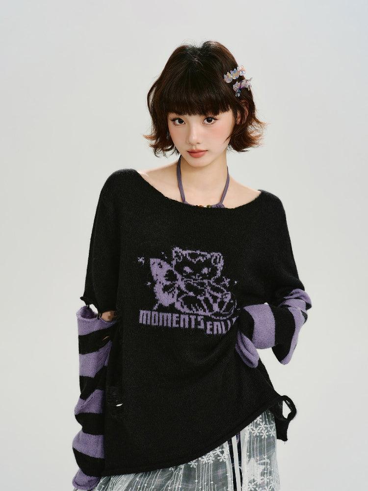 Model wearing a black knit sweater with purple graphic print and striped sleeves