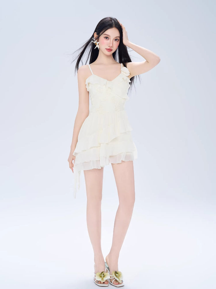 Full-length shot of a woman in a white chiffon dress with ruffled details