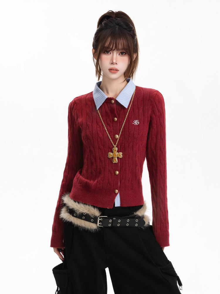 Woman wearing a red cable knit cardigan with a light blue collared shirt underneath, gold cross necklace, and black cargo pants.