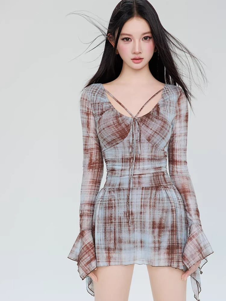 Close-up of the plaid pattern and neckline of the mini dress.