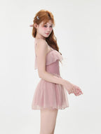 Side view of a woman in a pink ruffled swimsuit, showcasing the A-line silhouette.
