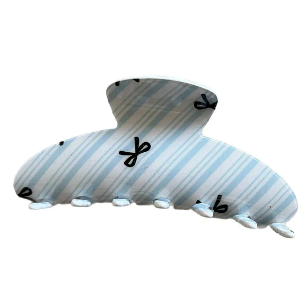 A light blue and white striped hair claw clip with black bow prints.