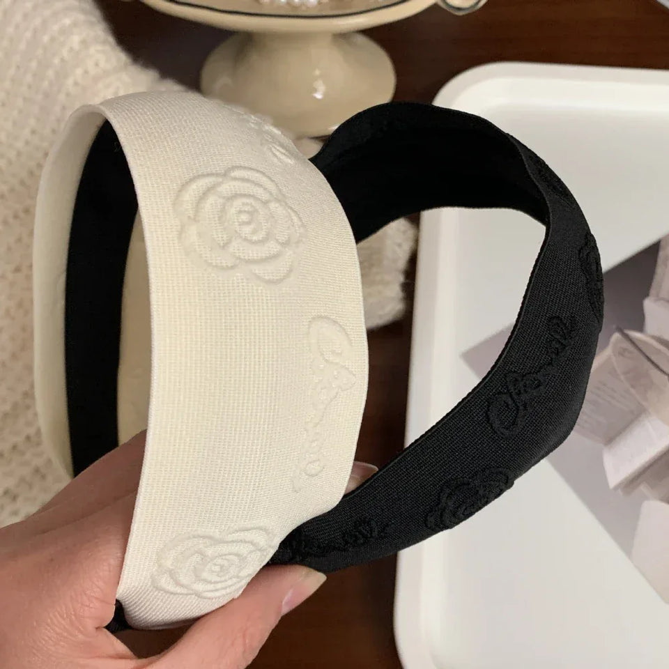White and black headbands with embossed floral and logo details Secondary image