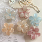 group of six flower claw clips in various pastel colors including peach, pink, and blue