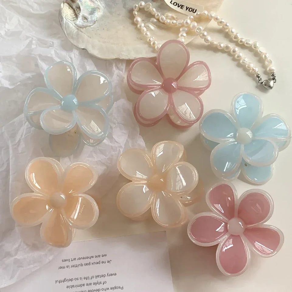 group of six flower claw clips in various pastel colors including peach, pink, and blue Secondary image