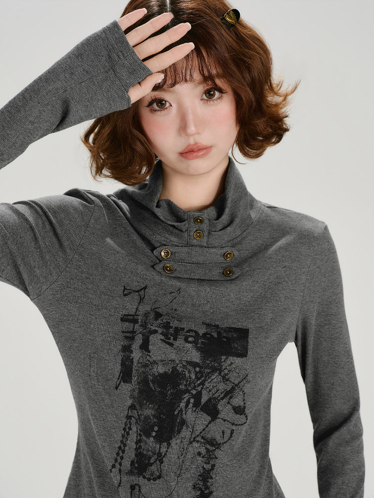 Close-up of a woman wearing a grey long-sleeve graphic print turtleneck top with button detailing at the neckline.