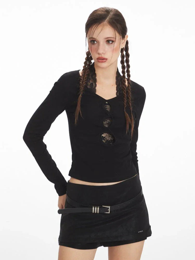 Woman with braids wearing a black long-sleeve top and black mini skirt