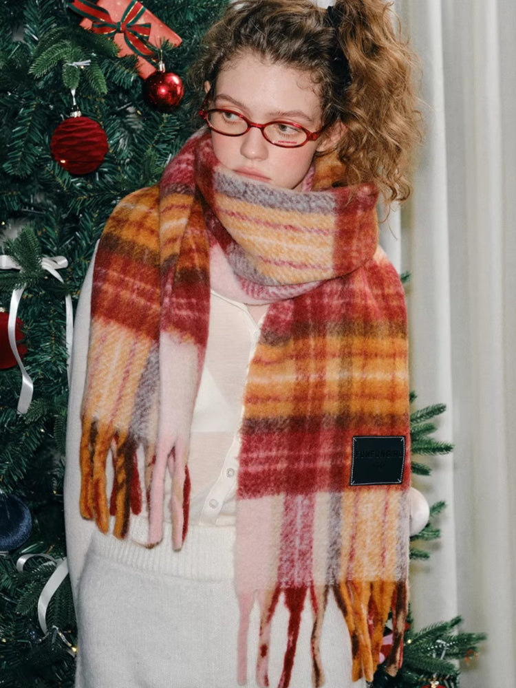 Model posing with a plaid scarf
