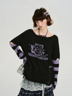 Close-up of the graphic print and distressed details on the sweater