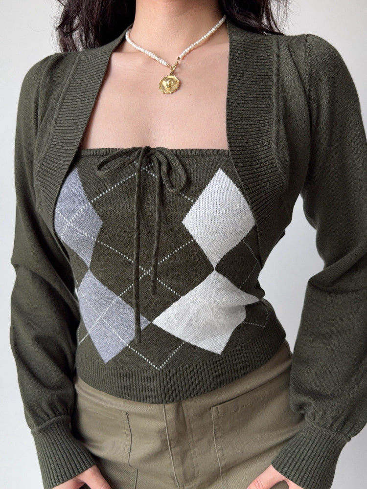 Close-up of a woman's torso wearing a green argyle knit tube top with a tie-front detail and a cropped green bolero cardigan.