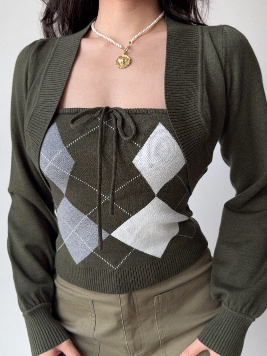 Close-up of a woman's torso wearing a green argyle knit tube top with a tie-front detail and a cropped green bolero cardigan.