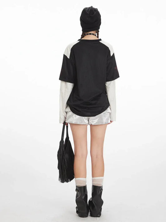 Back view of the outfit, showing the graphic print on the back of the shirt and the ruffled texture of the shorts.