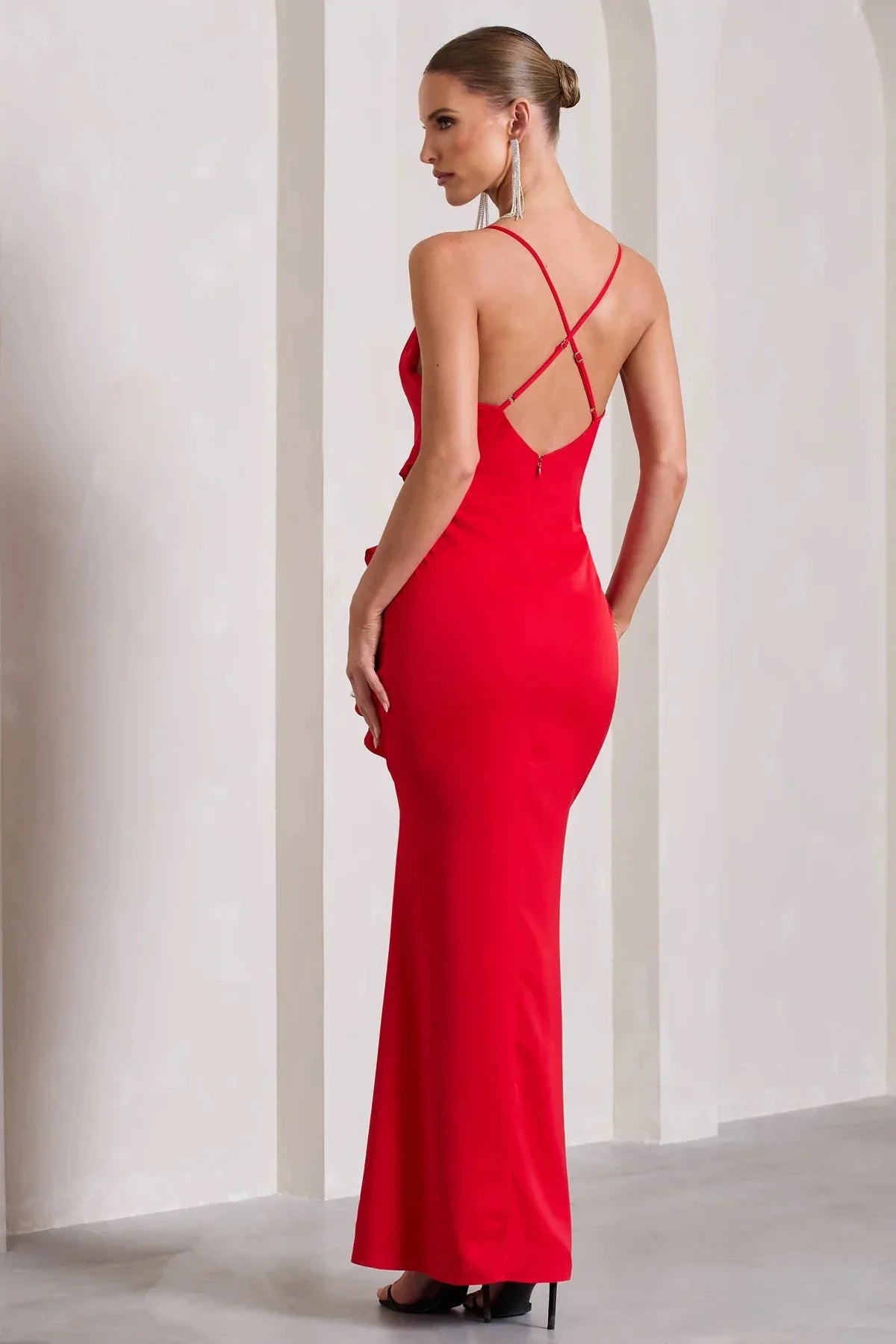 back view of a woman in a red satin evening dress with spaghetti straps