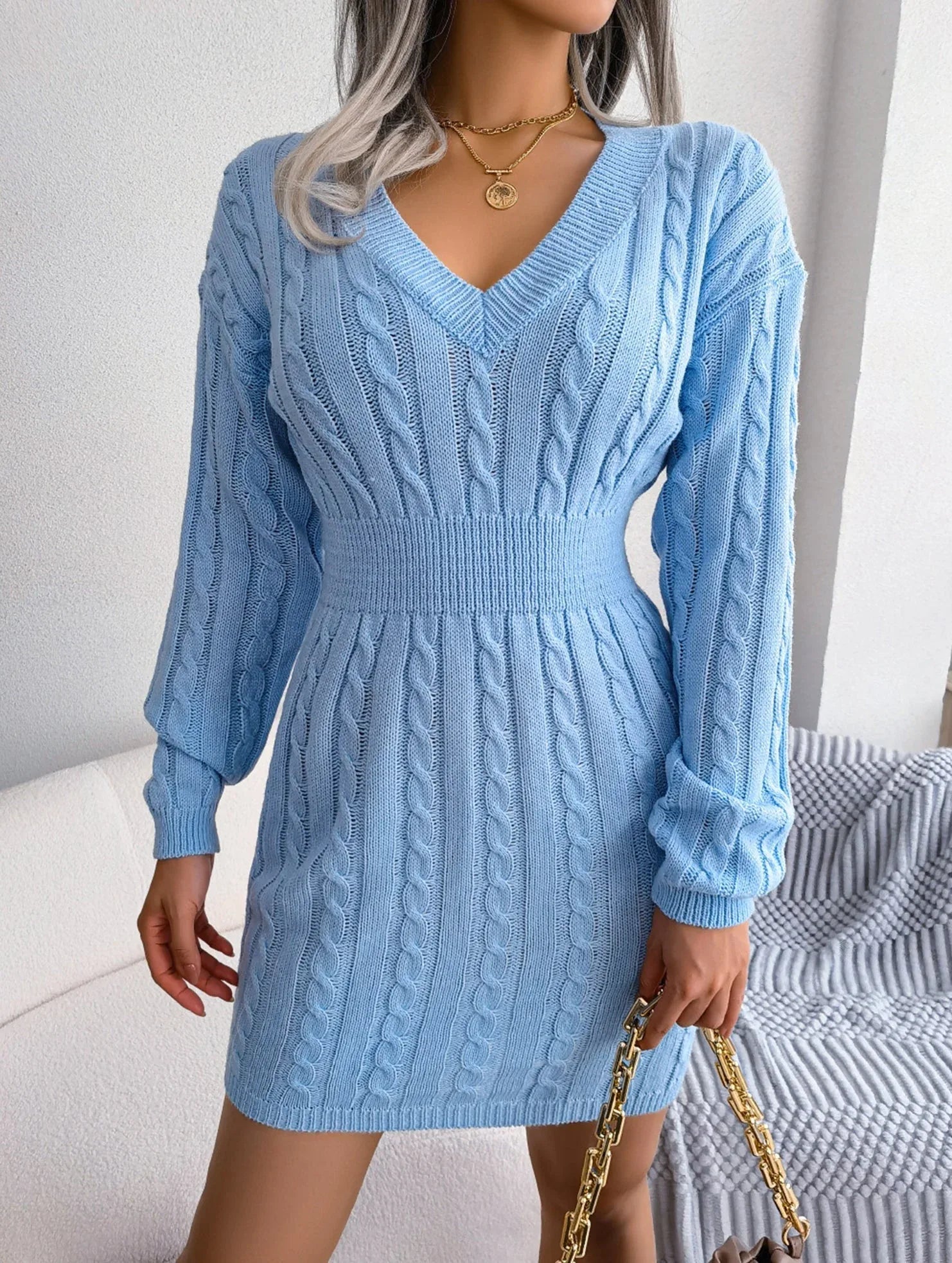 woman in a light blue cable knit bodycon dress