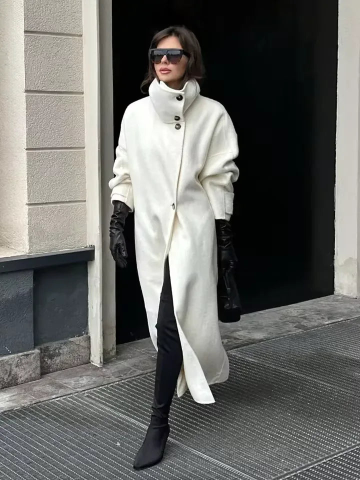 Woman wearing a white oversized wool blend coat with black leather gloves and boots