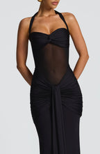 Close-up of the bodice and skirt of a black floor-length halter gown
