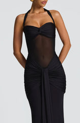 Close-up of the bodice and skirt of a black floor-length halter gown